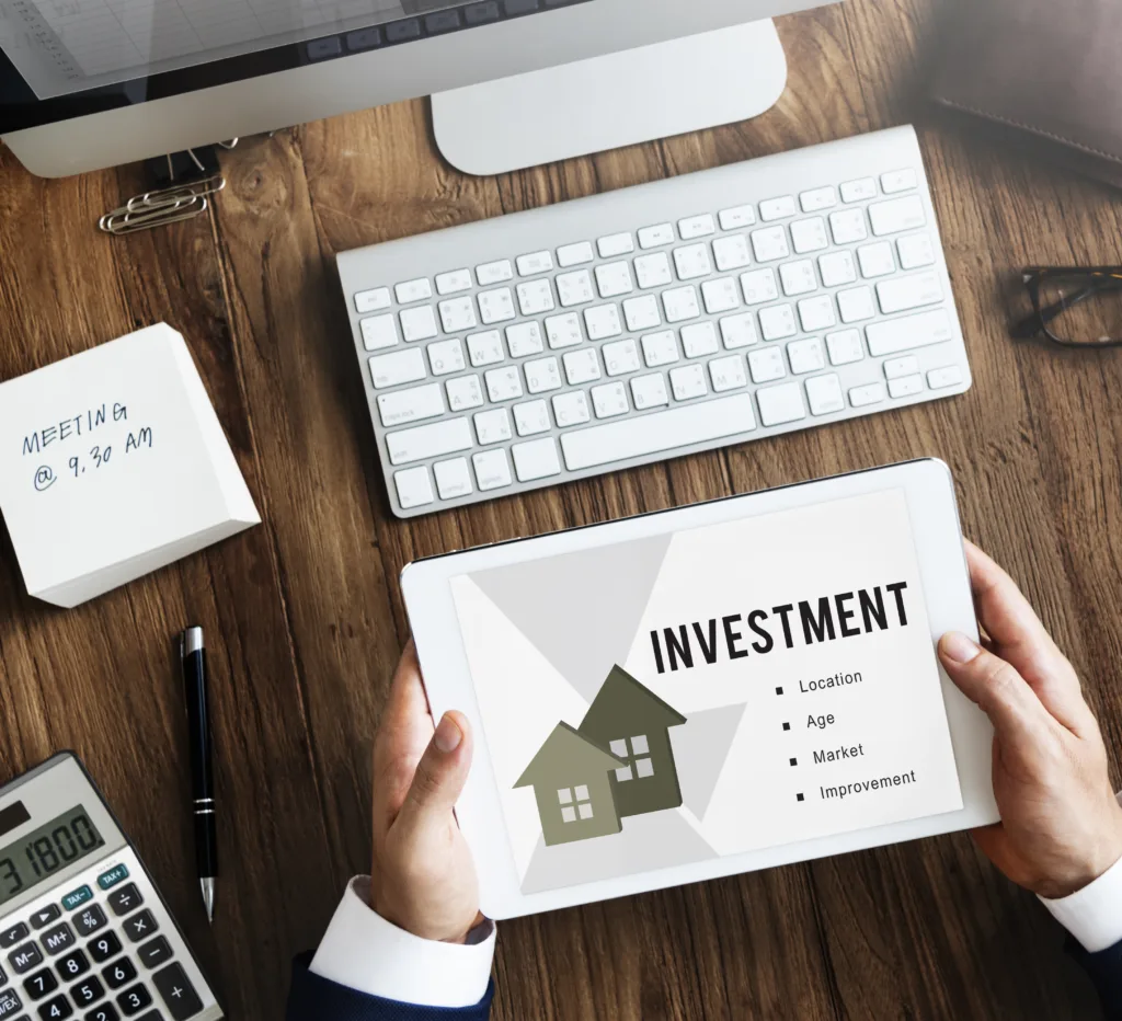 hands holding a white paper that says investment